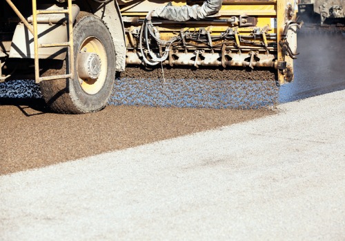 An Etnyre ChipSpreader spreading asphalt aggregate on pavement