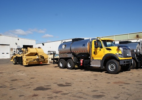 An asphalt distributor and chip spreader used in chip seal paving services