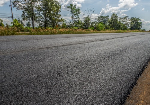 A freshly repaved roadway, thanks to Top-Rated Chip Spreaders in Arizona