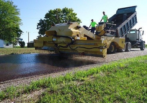 Top-Rated Chip Spreaders in Tennessee in operation, helping chip seal a road