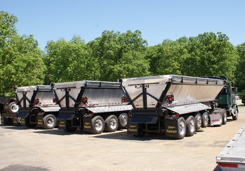 A row of Top-Rated Live Bottom Trailers, manufactured by Etnyre