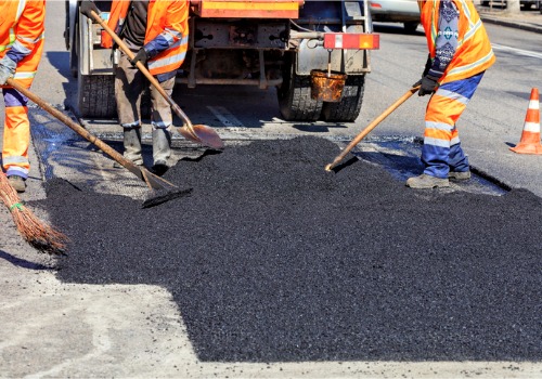 A team of workers tackle asphalt repair. When you need the Best Crack Sealers in Illinois, contact Etnyre.
