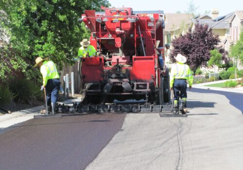 A RoadSaver machine covering a roadway with slurry seal