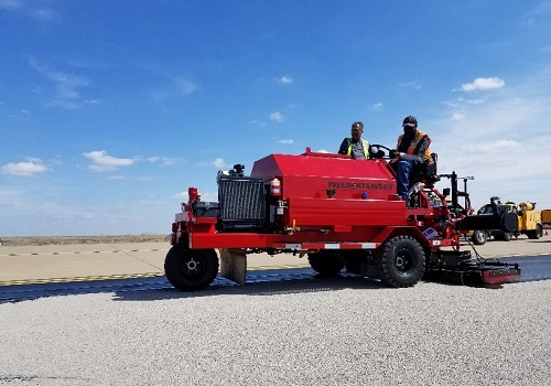 A red sealcoat buggy at work